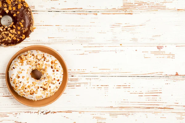 Tasty donuts on white wood background — Stock Photo, Image