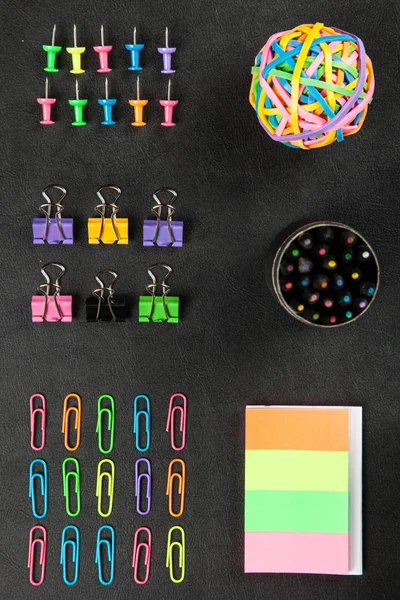 Office supplies on a black table — Stock Photo, Image