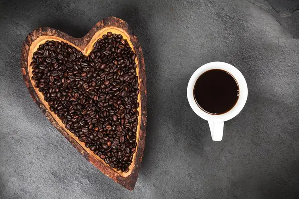 Granos de café en un tazón en forma de corazón — Foto de Stock