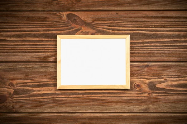 Picture frame on a wooden wall — Stock Photo, Image