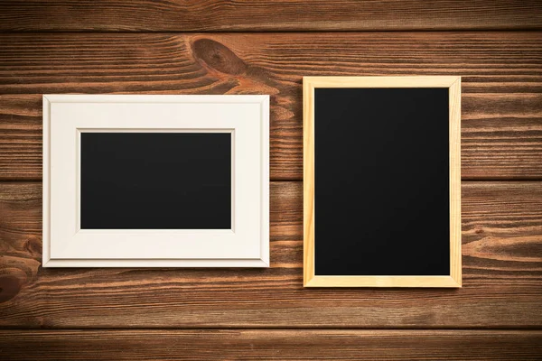 Picture frame on a wooden wall — Stock Photo, Image