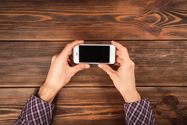 Male hands holding a smartphone — Stock Photo, Image