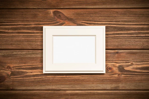 Picture frame on a wooden wall — Stock Photo, Image