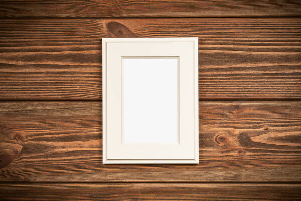 Picture frame on a wooden wall.