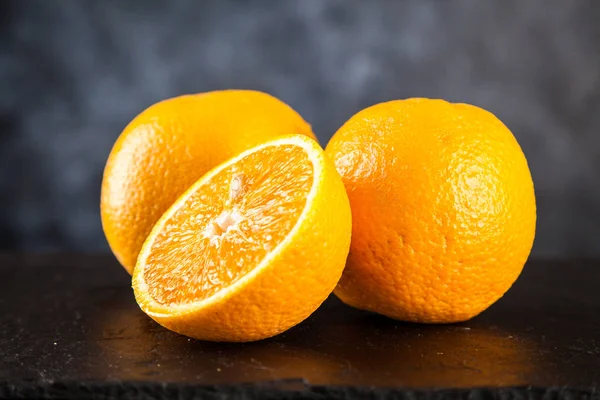 Fresh oranges on dark background — Stock Photo, Image