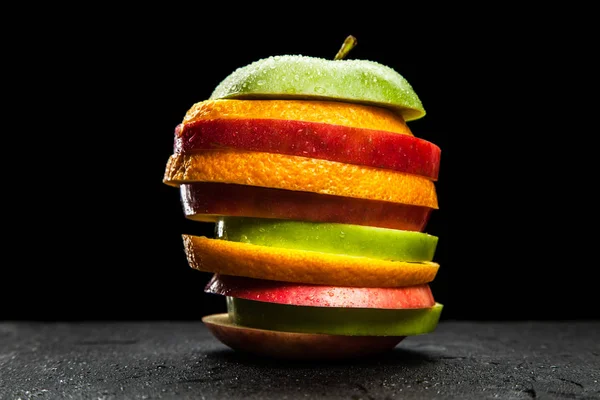 Rebanadas de fruta sobre fondo negro — Foto de Stock