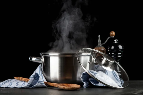 Steaming pot on black background — Stock Photo, Image