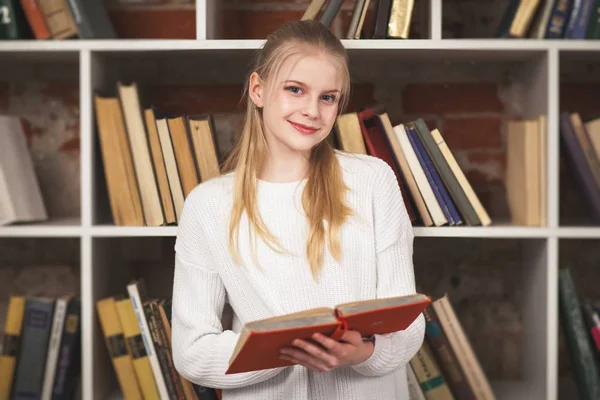 Tiener meisje in een bibliotheek — Stockfoto