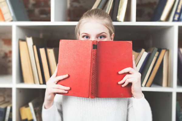 Tonårig flicka i ett bibliotek — Stockfoto