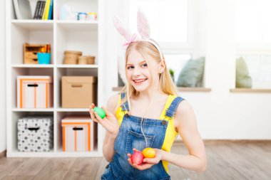 Paskalya yumurtaları tutan genç kız