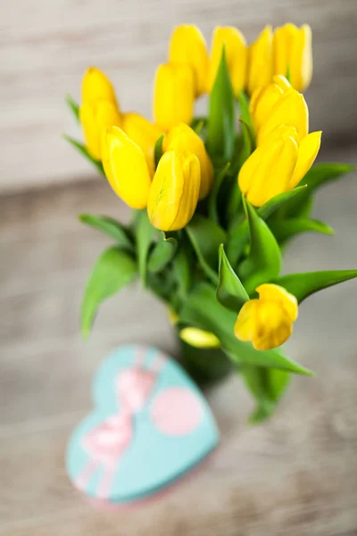 Yellow tulips on wooden background — Stock Photo, Image