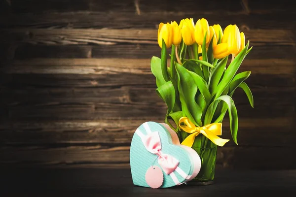 Yellow tulips on wooden background — Stock Photo, Image