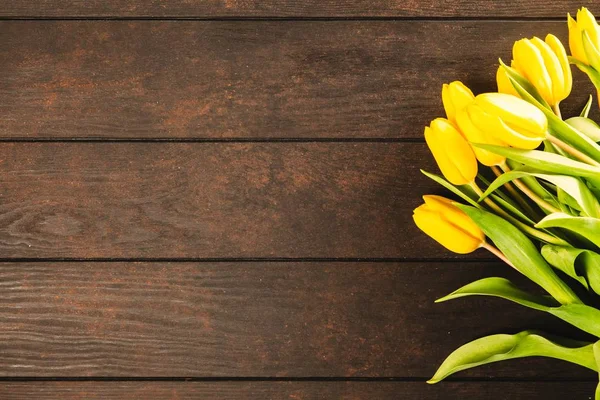 Yellow tulips on wooden background — Stock Photo, Image