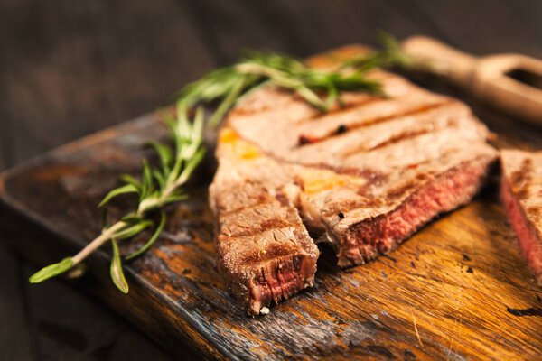 Grilled beef steak on a wooden cutting board