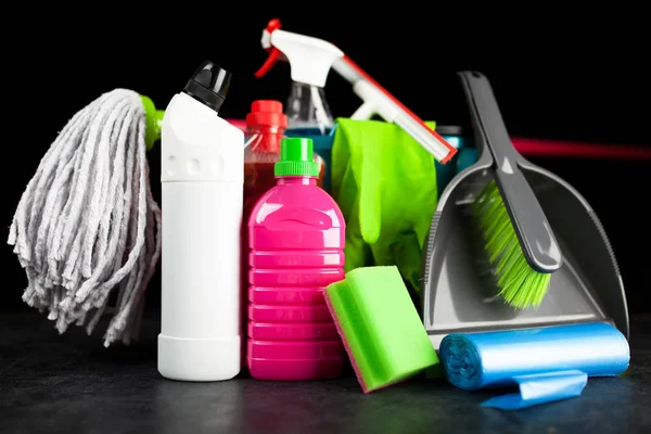 Cleaning supplies on black background — Stock Photo, Image