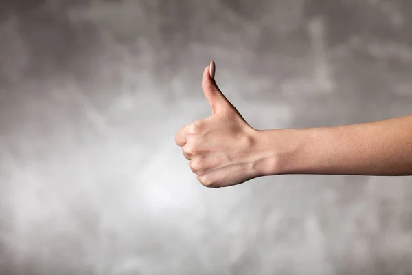 Female hand on dark background — Stock Photo, Image