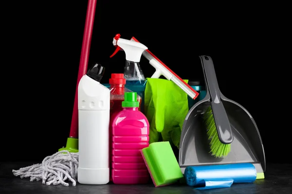 Cleaning supplies on black background — Stock Photo, Image