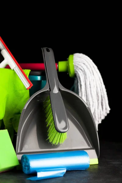 Cleaning supplies on black background — Stock Photo, Image