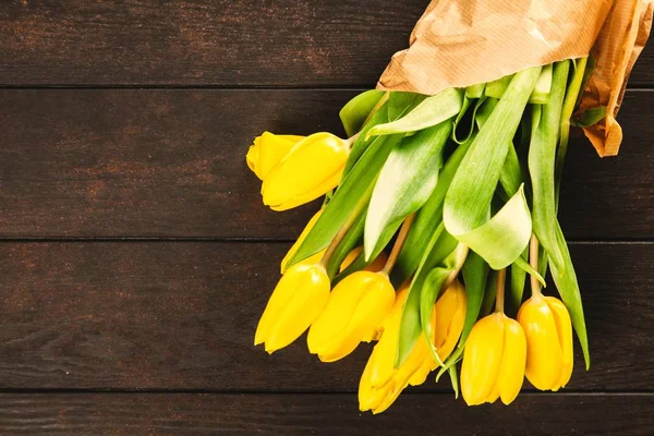 Yellow tulips on wooden background — Stock Photo, Image