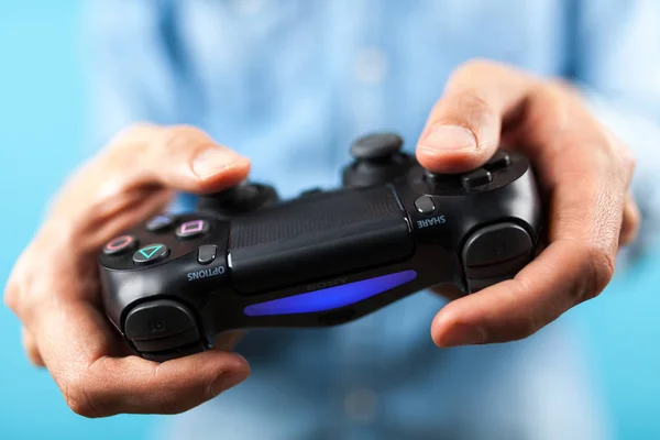 Manos masculinas sosteniendo un controlador PS4 — Foto de Stock