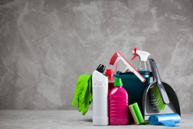 Cleaning supplies on grey background clipart