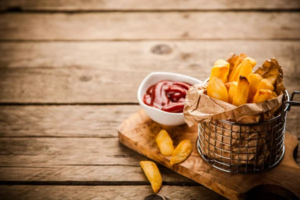 French fries on wooden table — Stock Photo, Image