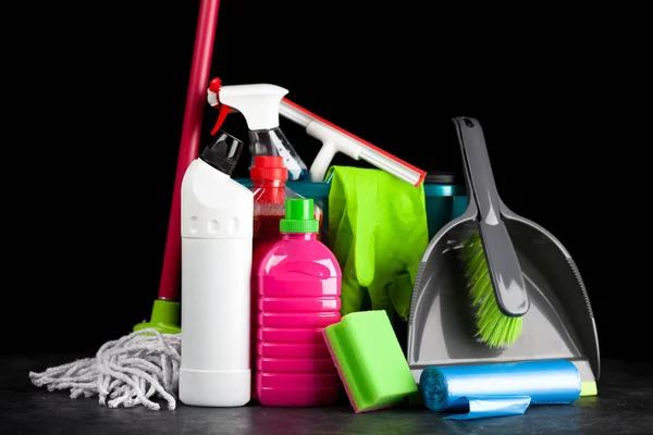 Cleaning supplies on black background — Stock Photo, Image