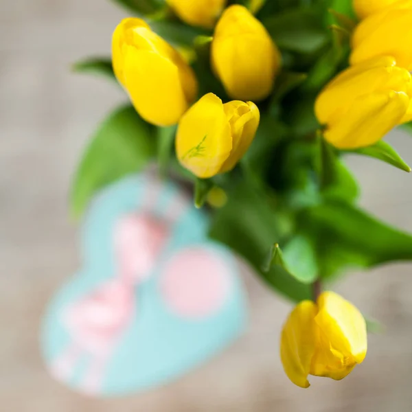 Yellow tulips on wooden background — Stock Photo, Image