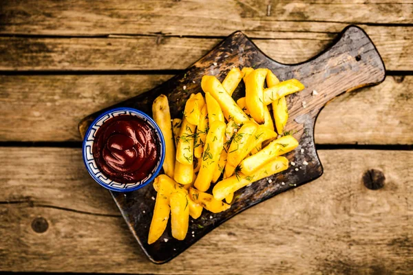 French fries on wooden table — Stock Photo, Image