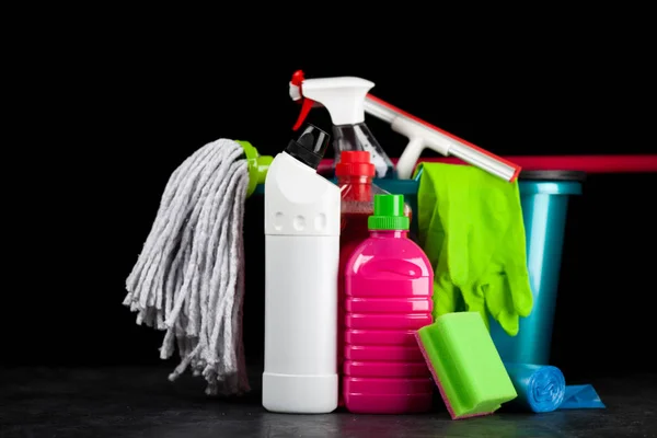 Cleaning supplies on black background