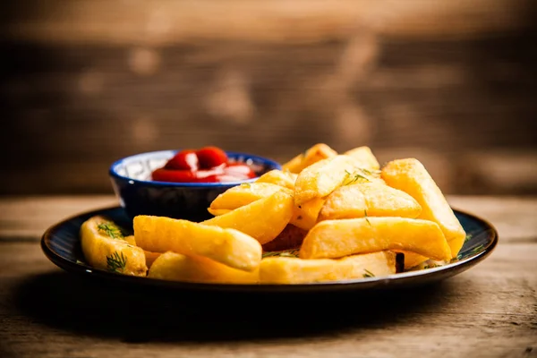 Batatas fritas na mesa de madeira — Fotografia de Stock