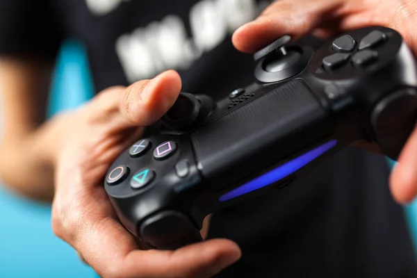 Mãos masculinas segurando um controlador PS4 — Fotografia de Stock
