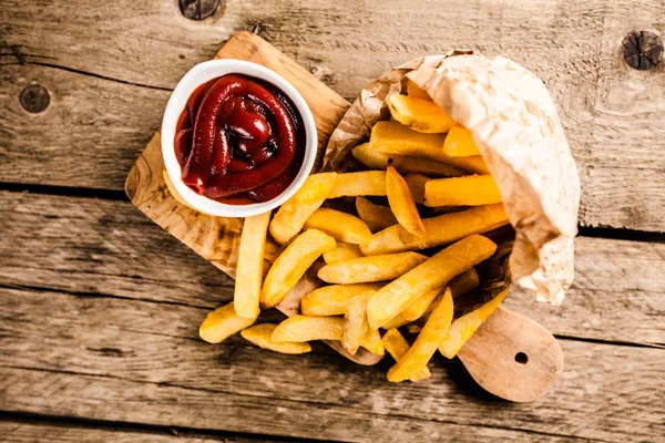 Pommes frites på träbord — Stockfoto