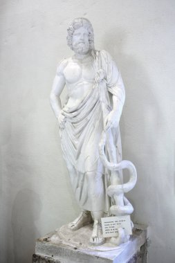 Statue of Asclepius in museum of Epidauros, Greece clipart
