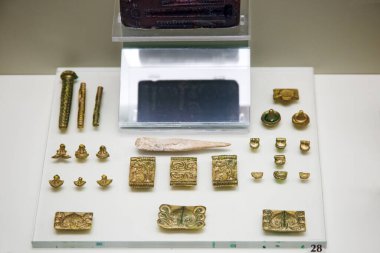 Mycenae, Greece - August, 30, 2019. Gold objects on display of Mycenaen museum. In the second millennium BC, Mycenae was one of the major centres of Greek civilization. clipart