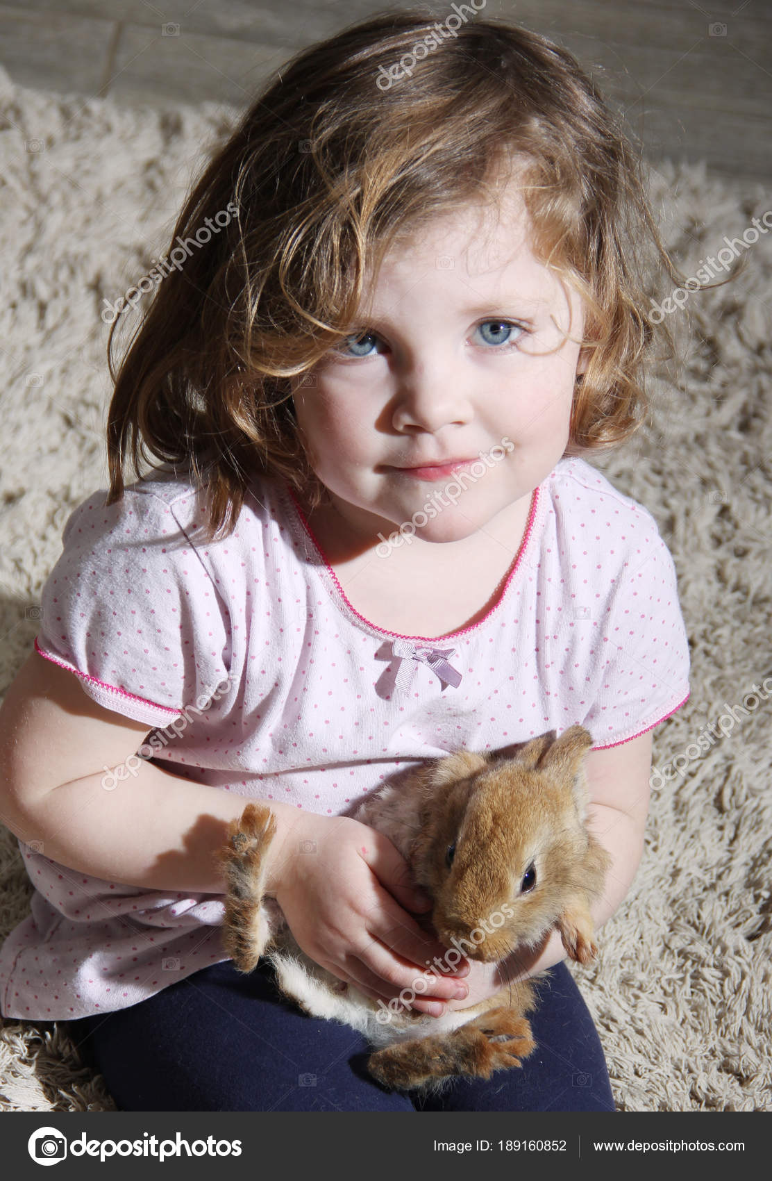 Cute Blond Hair Blue Eyes Little Girl Holding Bunny Stock Photo