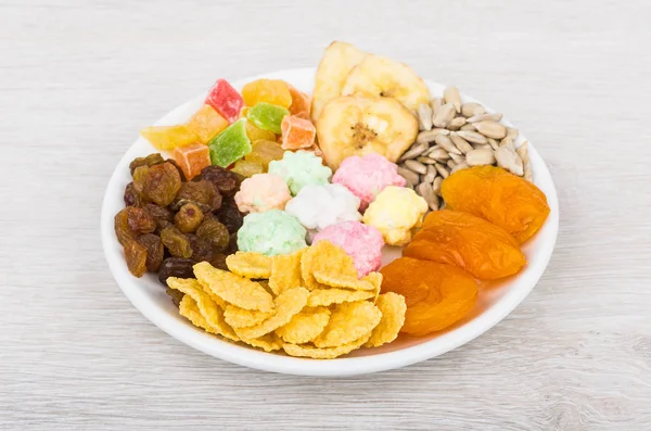 Dried fruit, sunflower seeds, corn flakes and nuts in sugar