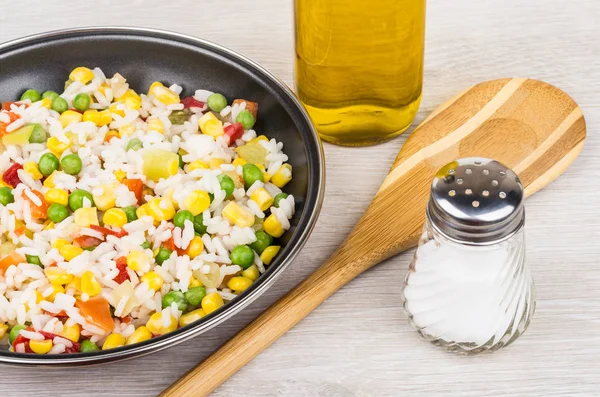 Frying pan with vegetable mix, bamboo spoon, vegetable oil