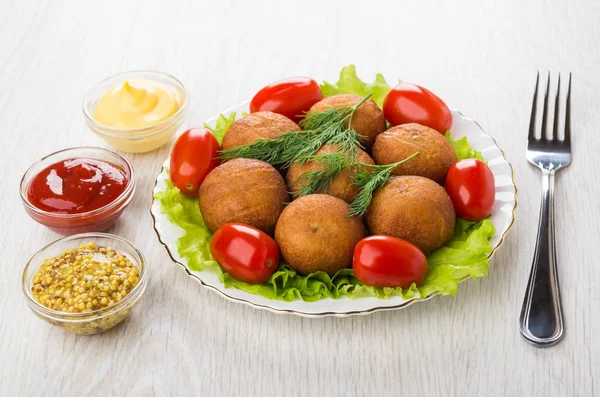 Fried pies stuffed with meat, lettuce, tomatoes, bowls with sauc