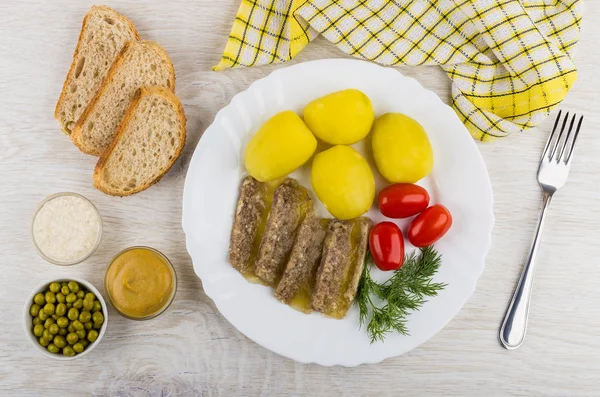 Plate with meat aspic, potatoes, tomatoes, horseradish, mustard,