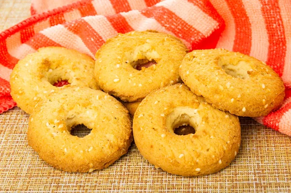 Shortbread rings with sesame, napkin on brown mat