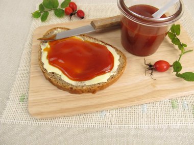 Sliced bread with rose hip jam for breakfast clipart