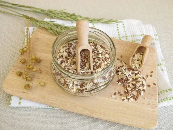 Seed mixture in jar with rolled oats, flaxseeds, and sesame — Stock Photo, Image