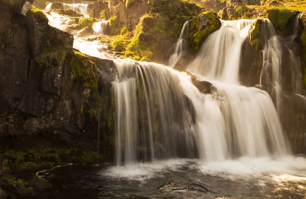 small waterfall at sunset