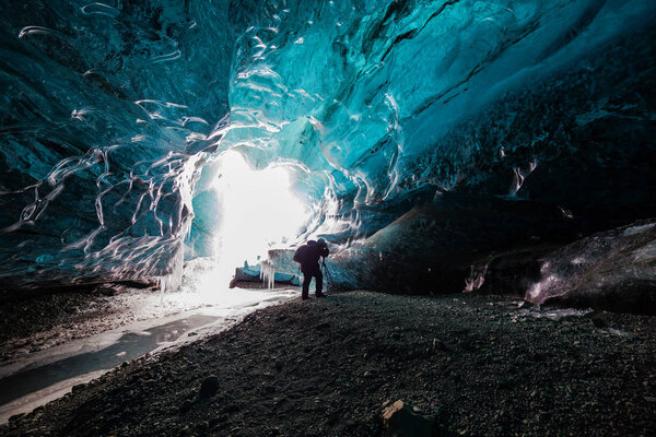 tourist inside ice cave in Iceland