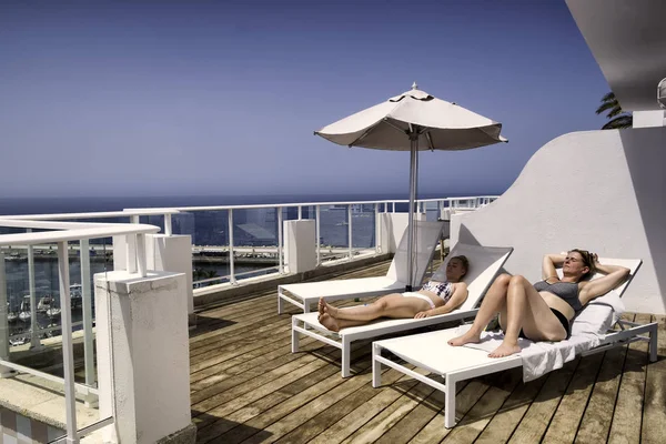 Two Women Sunbathing Hotel Resort Southern Europe Lying Sunbeds Ocean Stock Picture