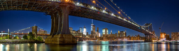 Manhattan and Brooklyn Bridge panorama with skyline at dusk, New York