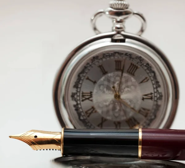 Pen and pocket watch — Stock Photo, Image