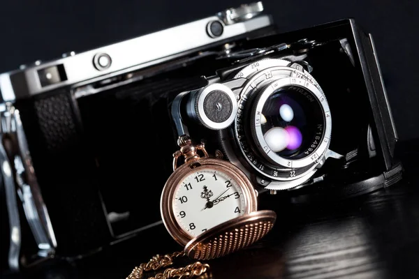 Retro camera and pocket watch — Stock Photo, Image