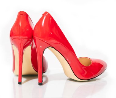 female shiny red stilettos on a white background